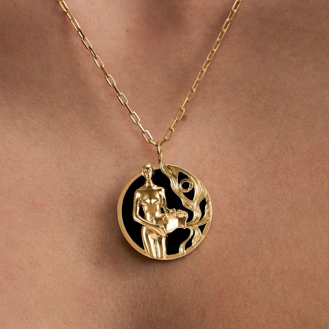 Model wearing Aquarius zodiac necklace in sterling silver with 18k gold plating