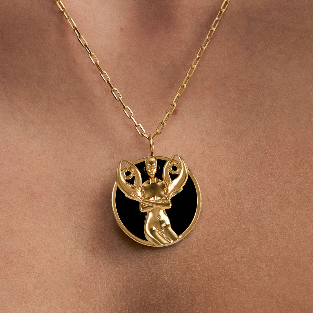 Model wearing Cancer zodiac necklace in sterling silver with 18k gold plating