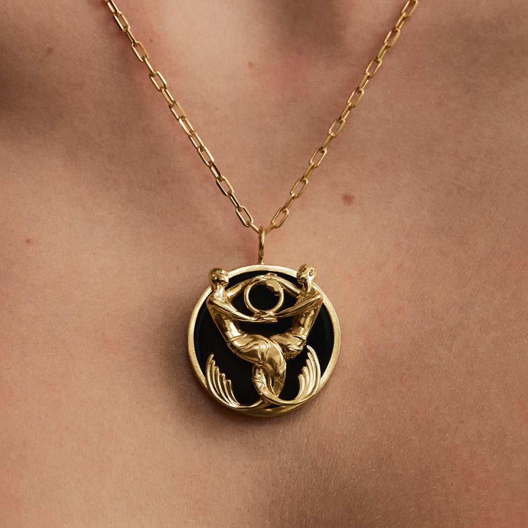 Model wearing Pisces zodiac necklace in sterling silver with 18k gold plating