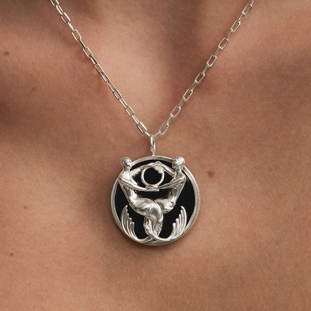 Model wearing Pisces zodiac necklace in sterling silver