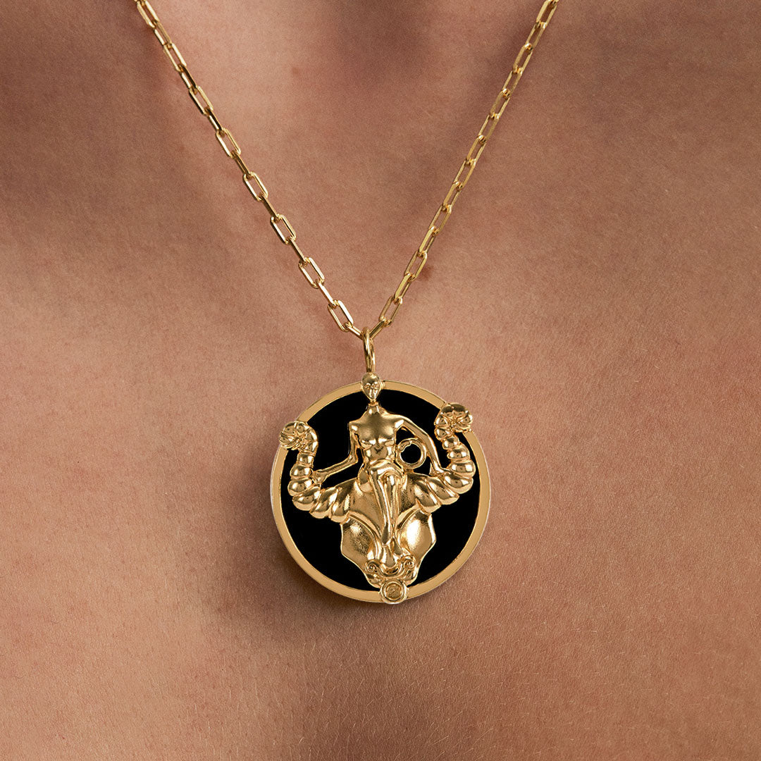 Model wearing Taurus zodiac necklace in sterling silver with 18k gold plating