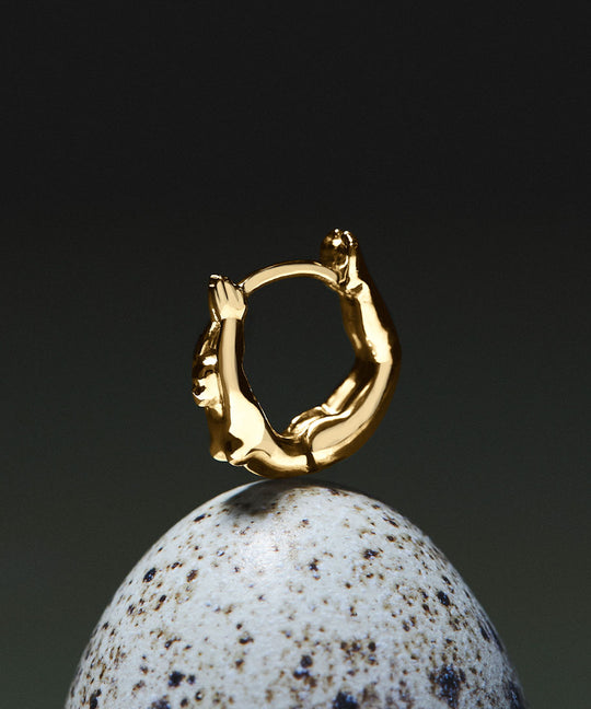 Female body piercing in 18k gold