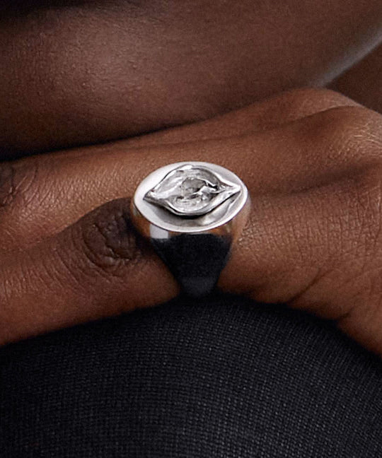 Model wearing a chevalier ring of a vulva in sterling silver