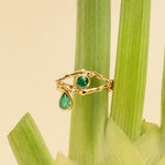 18k gold eye ring with tear adorned with emeralds