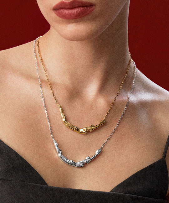 Model wearing sterling silver necklaces with 18k gold plating of female bodies