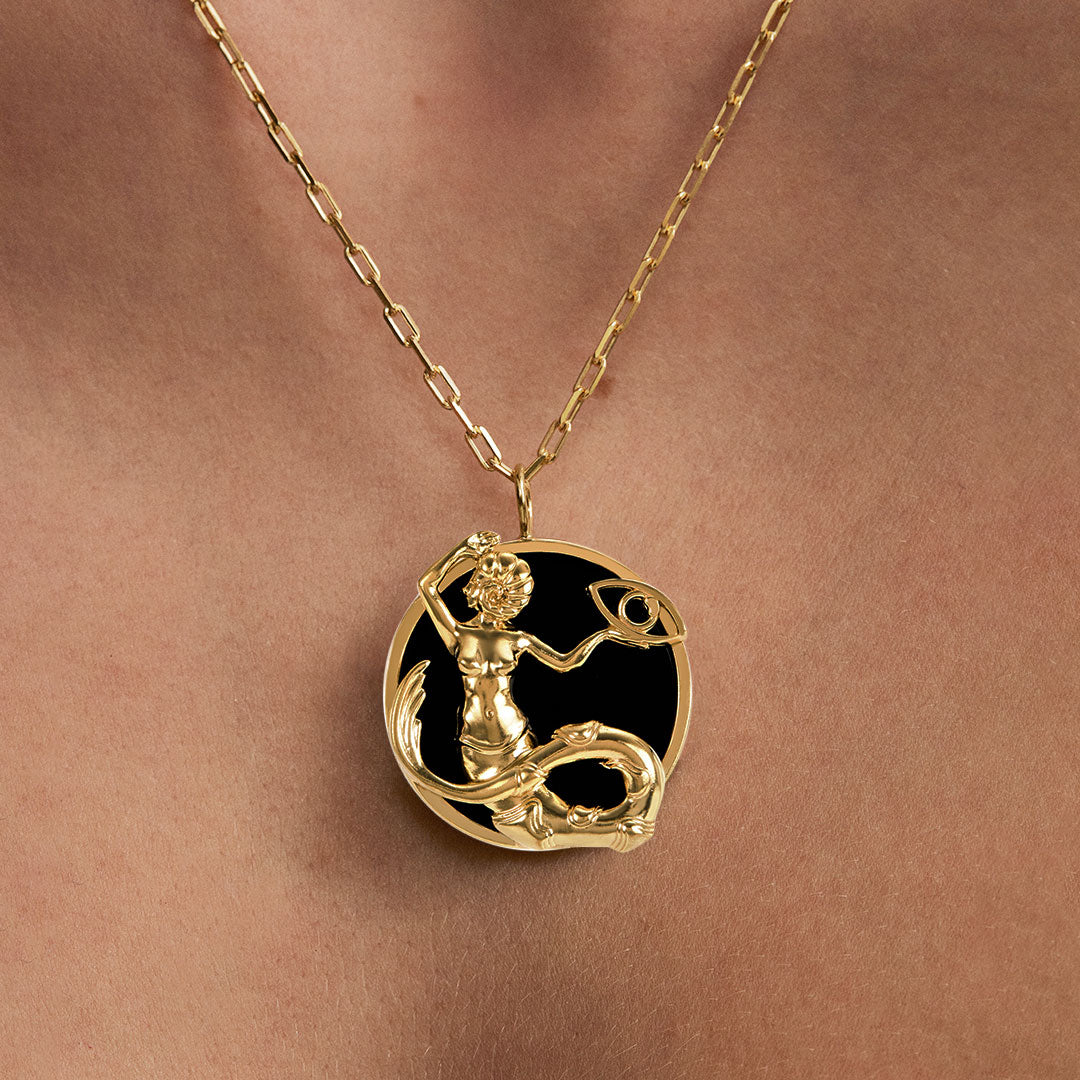 Model wearing Capricorn zodiac necklace in sterling silver with 18k gold plating