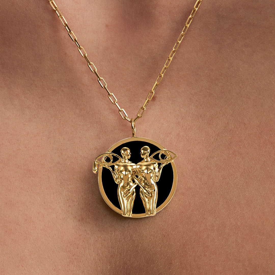 Model wearing Gemini zodiac necklace in sterling silver with 18k gold plating
