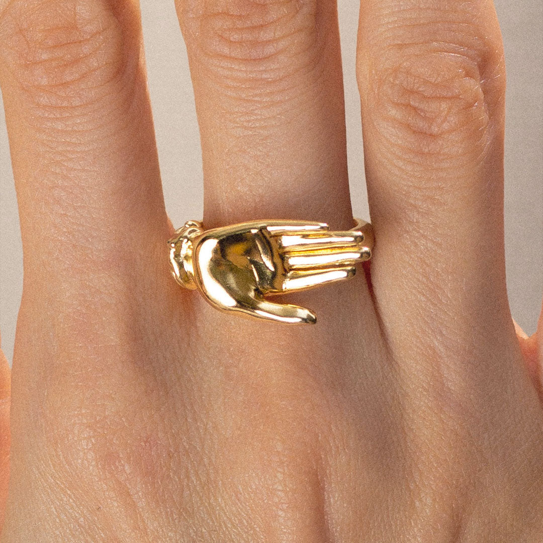 Model wearing a palm ring in sterling silver with 18k gold plating