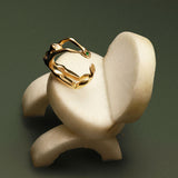 Paola Vilas 18k gold ring of a female body with an emerald