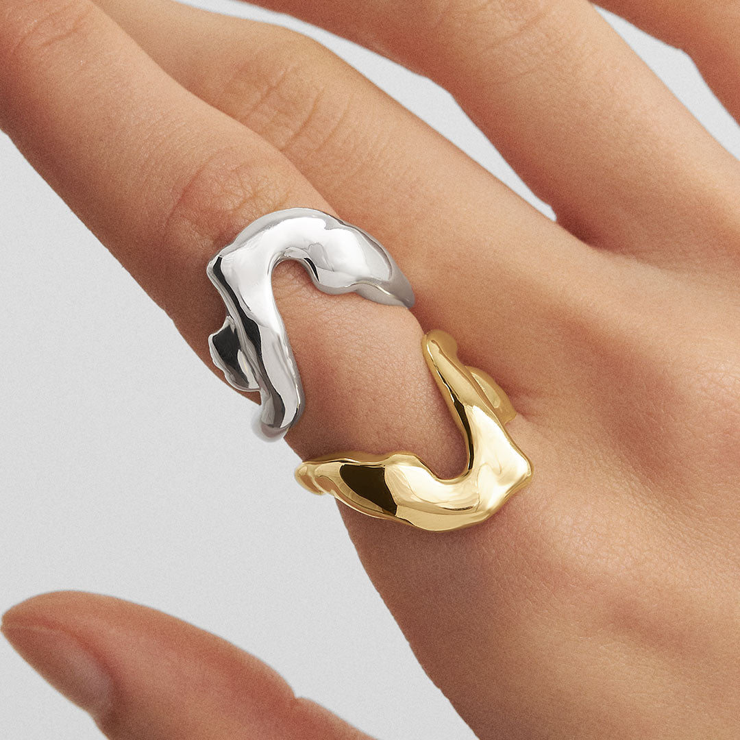 Model wearing sterling silver rings with 18k gold plating of a melted female body