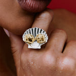 Model wearing a shell ring in sterling silver with women in 18k gold plating