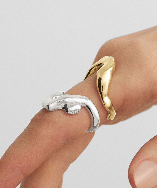 Hand model wearing rings of a melted female body in sterling silver and 18k gold plating