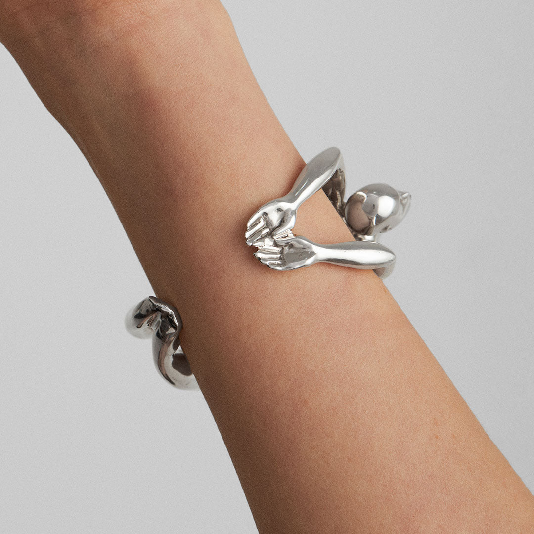 Model wearing a sterling silver bracelet with a sculptural female body