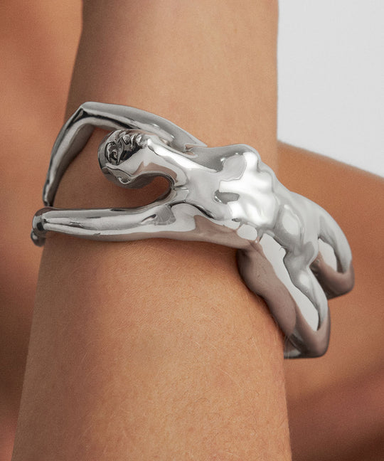 Model wearing a sterling silver bracelet featuring a woman’s body