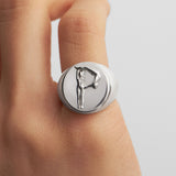 Model wearing a sterling silver chevalier ring of the letter P